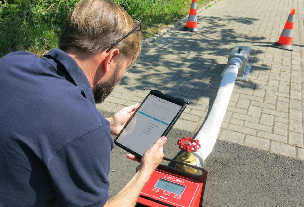 Photo: Man records readings from a hydrant tester using an app
